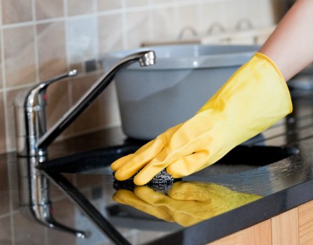 Technician treating stains on upholstered furniture in West Ham